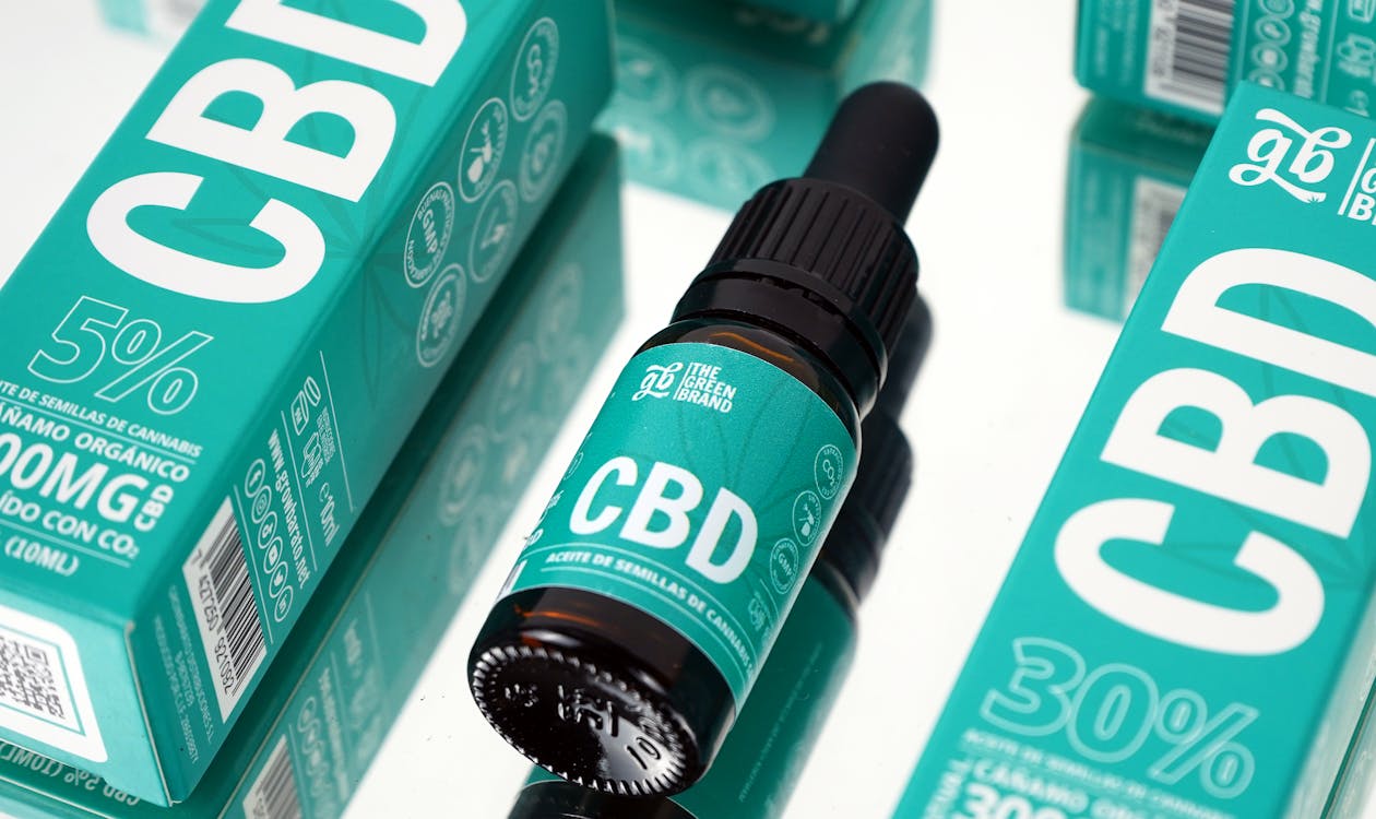 Three CBD formats side by side — tincture bottle, capsule pill, and gummy candy